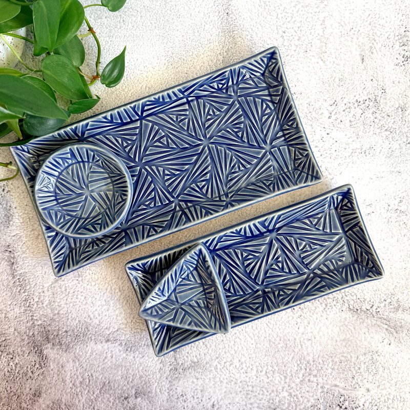 Blue carved rectangular trays with matching small dishes.